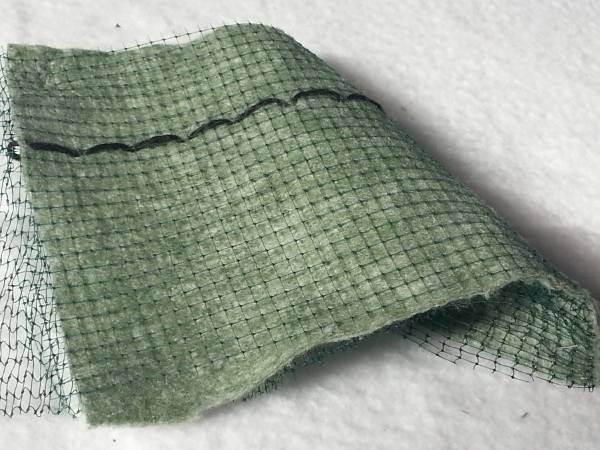 A biodegradable textile is sewn underneath the 3D geomat.