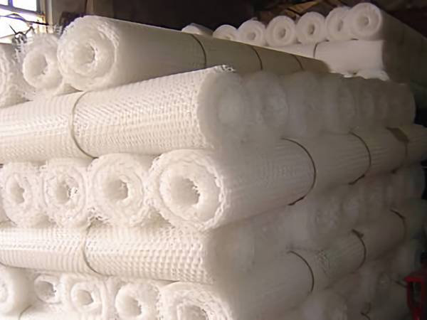 White plastic flat netting rolls in warehouse