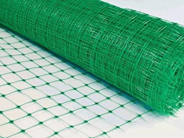 A roll of green extruded plastic netting with square mesh opening
