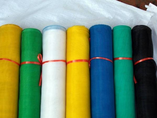 Six rolls of plastic screen in yellow, white, blue and green colors