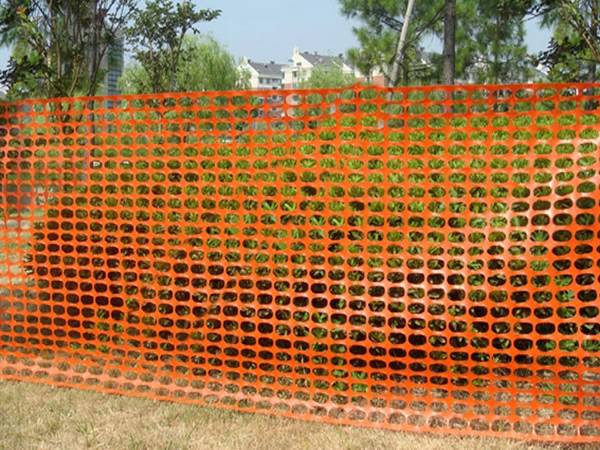 Orange safety netting for farm land protection fencing